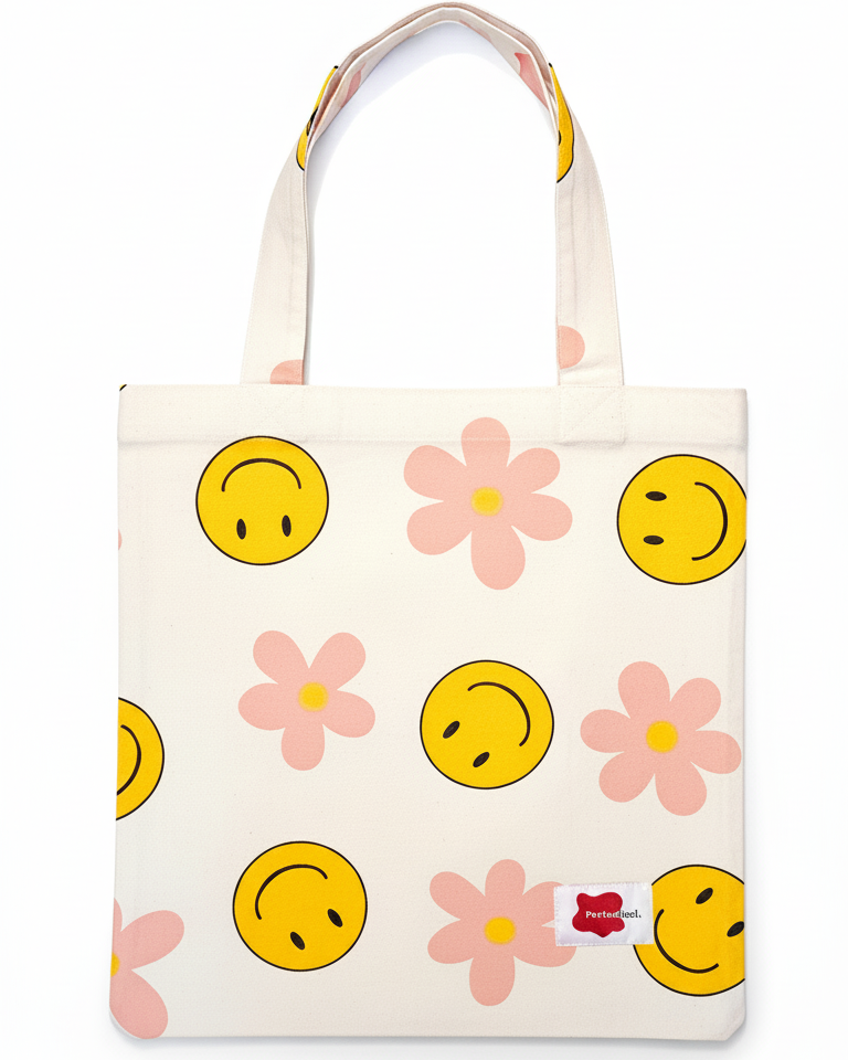 white tote bag with smiley face and flower patterns on a white background
